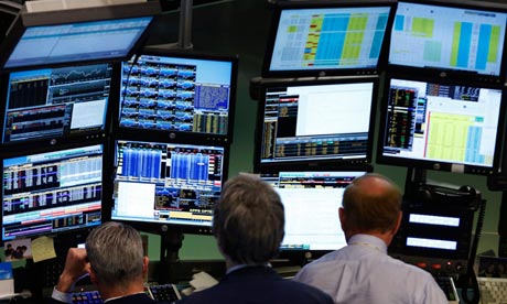 Traders work at Bloomberg terminals on the floor of the New York Stock Exchange