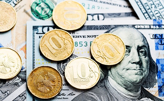russian roubles coins on banknotes of  dollars